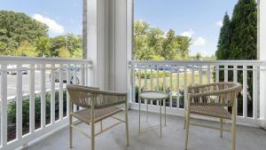 two chairs and a table on a balcony at Landing Modern Apartment with Amazing Amenities (ID1358X777) in Chapel Hill