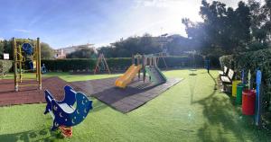 a park with a playground with a slide at Bellissimo appartamento con veranda privata al centro di Porto Rotondo in Porto Rotondo