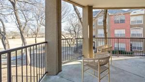 a balcony with a table and chairs and a building at Landing Modern Apartment with Amazing Amenities (ID8229X54) in Plano