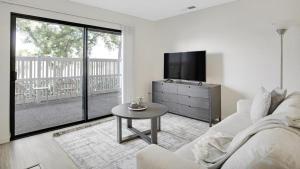 a living room with a white couch and a tv at Landing Modern Apartment with Amazing Amenities (ID1233X125) in Redlands