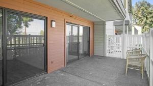 a porch with a chair and a sliding glass door at Landing Modern Apartment with Amazing Amenities (ID1233X125) in Redlands