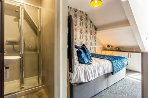 a small bedroom with a bed and a shower at Room 07 - Sandhaven Rooms Double in South Shields