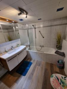 a bathroom with a tub and a sink and a shower at Schnuckelige Wohnung in Marl