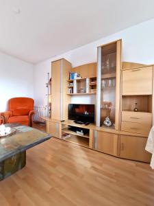 a living room with a flat screen tv and wooden cabinets at Ferienpark P05-008 Ferienpark in Heiligenhafen