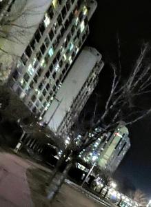 a tall building at night with a building at 천성리버 아파트 집전체 렌트 in Yangsan