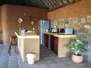 a kitchen with a refrigerator and a counter top at Casa Luna Playa in Puerto Ángel