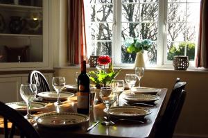 a table with a bottle of wine and glasses at Minafon near Barmouth in Llanaber