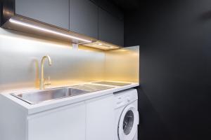 a kitchen with a sink and a washing machine at Marcq-en-Baroeul - Beautiful apartment Art-déco ! in Marquette-lès-Lille