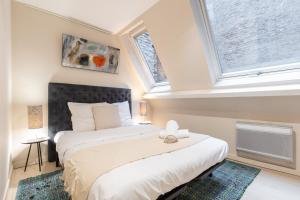 a bedroom with a large bed and a window at Old Lille - Superb apartment 2 bedrooms. in Lille