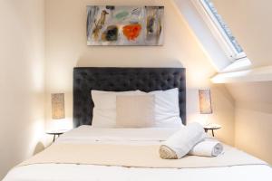 a bedroom with a bed with a black headboard at Old Lille - Superb apartment 2 bedrooms. in Lille +10 photos