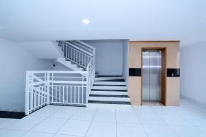 a staircase in a building with a white stair case at Kings Fort in Cochin