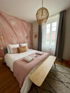 een slaapkamer met een groot bed en een groot raam bij MAISON LE BEAULIEU in Vichy