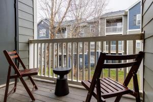 a porch with a chair and a stool on a balcony at Landing Modern Apartment with Amazing Amenities (ID4329) in Mount Juliet