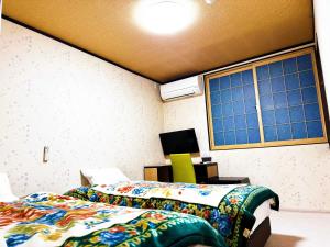 Postel nebo postele na pokoji v ubytování Onsen Yado Misuzuso