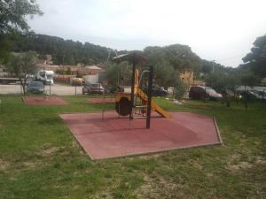 a playground in a park with a yellow slide at Domaine des voiles de Pierrefeu in Pierrefeu-du-Var