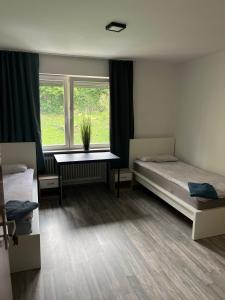 a bedroom with two beds and a window at Eventus-House in Horb am Neckar