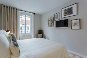 Gasparin - Studio - Lyon 2 في ليون: غرفة نوم مع سرير وتلفزيون على الحائط