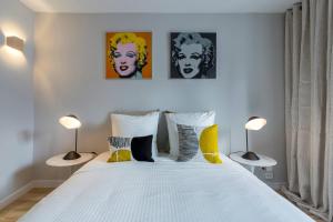 una camera da letto con un grande letto bianco con due lampade di Gasparin - Studio - Lyon 2 a Lione
