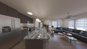 a kitchen and living room with a couch and a table at Landing Modern Apartment with Amazing Amenities (ID9574X29) in Middleburg