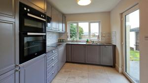 a kitchen with a sink and a stove top oven at 2 minute walk to LUAS (tram) in Dublin