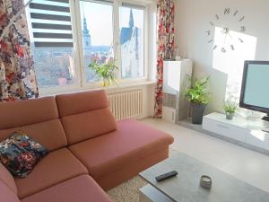 a living room with a couch and a tv at Apartmán Kolářová in Klatovy