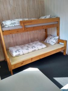 two bunk beds sitting in a room with a wall at Frivoll, 35 minutes walk to town. in Arendal