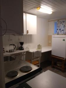 a kitchen with a sink and a stove top oven at Frivoll, 35 minutes walk to town. in Arendal