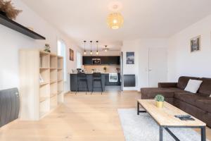a living room with a couch and a table at Beautiful apartment equipped near train parking in Lille