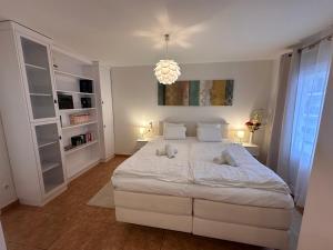 a bedroom with a large white bed with two pillows at WohnungAltea - Kirche, Berge, am Meer in Altea