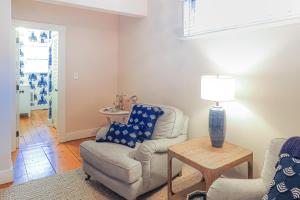 a living room with a couch and a chair and a table at Sea Lyon in Nantucket