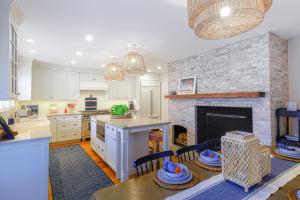 a kitchen and a living room with a fireplace at Sea Lyon in Nantucket