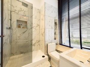 a bathroom with a shower and a toilet and a sink at Be London - Covent Garden Apartments in London