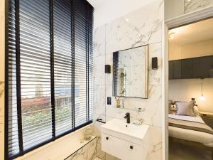 a bathroom with a sink and a mirror at Be London - Covent Garden Apartments in London