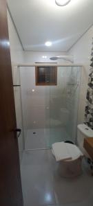 a bathroom with a shower with a toilet and a sink at Recanto do Sossego in São Sebastião +68 photos