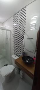 a bathroom with a sink and a toilet and a shower at Recanto do Sossego in São Sebastião