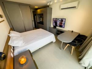 um pequeno quarto com uma cama e uma secretária em Flat em Boa Viagem Rooftop 470 Conforto e Localização privilegiada no Recife
