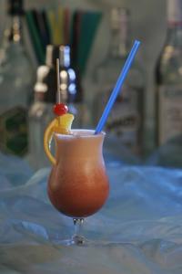 a drink sitting on a table with two straws at TOUCH DOWN Motel in Lohmar