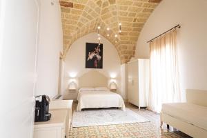 a bedroom with a bed in a room at Palazzo Alma luxury rooms in Casarano +54 photos