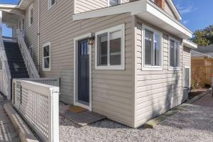 a small house with a door and a porch at Beachwalk #5 8 Mins to Beach in Virginia Beach