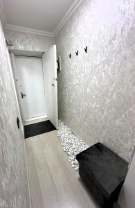 a room with a white door and a pebble floor at Fresh and cozy apartmrent in Yakkasaray