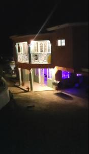 a house with a balcony with purple lights on it at Belle Air Seaview (2 BDRM 2 King) in Runaway Bay