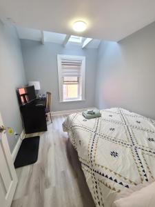 a bedroom with a bed and a desk and a window at Spacious room in downtown Ottawa. Room #1 in Ottawa