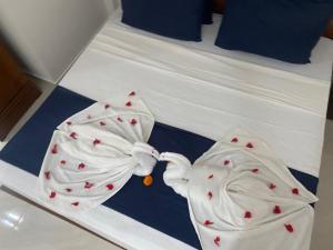 a couple of white towels on a bed at Sandaru villa in Induruwa