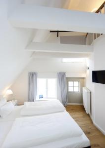 Postel nebo postele na pokoji v ubytování einzigartig - Das kleine Hotel im Wasserviertel