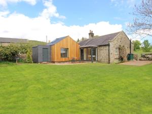 a house with a green lawn in front of it at 3 Bed in Northumberland National Park CN039 in Alwinton