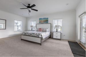 a bedroom with a bed and a ceiling fan at Wolf Bay Hangout in Coffeyville