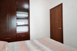 A bed or beds in a room at Depa 68 Con Terraza y Vista a la Ciudad