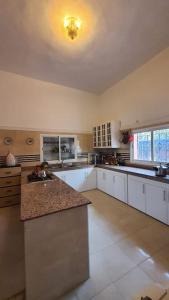a large kitchen with white cabinets and a ceiling at Marrakech Luxury Villa Farm in Marrakech