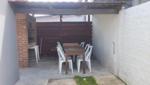 a table and chairs sitting under a pergola at Rubedo - Punta Fria in Piriápolis