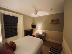 a bedroom with a bed and a desk and a window at Middle House in Askrigg